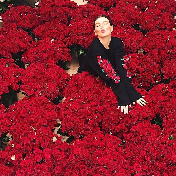 Анна Седокова спрятала свой животик среди букетов красных роз