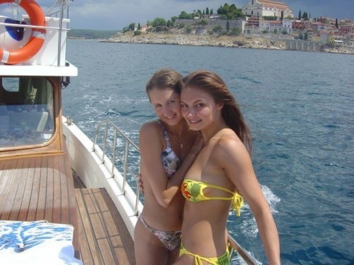 The network is discussing a photo of young Alina Kabaeva in a bikini on a y...